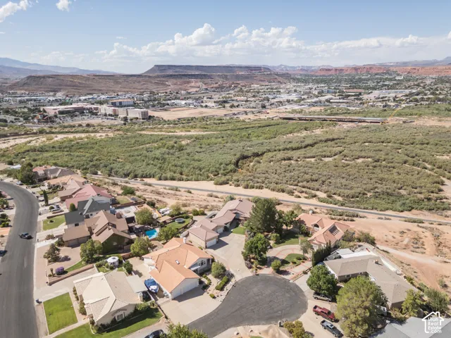 Residential neighborhood with a cul-de-sac, surrounded by natural desert landscaping and distant mountain ranges