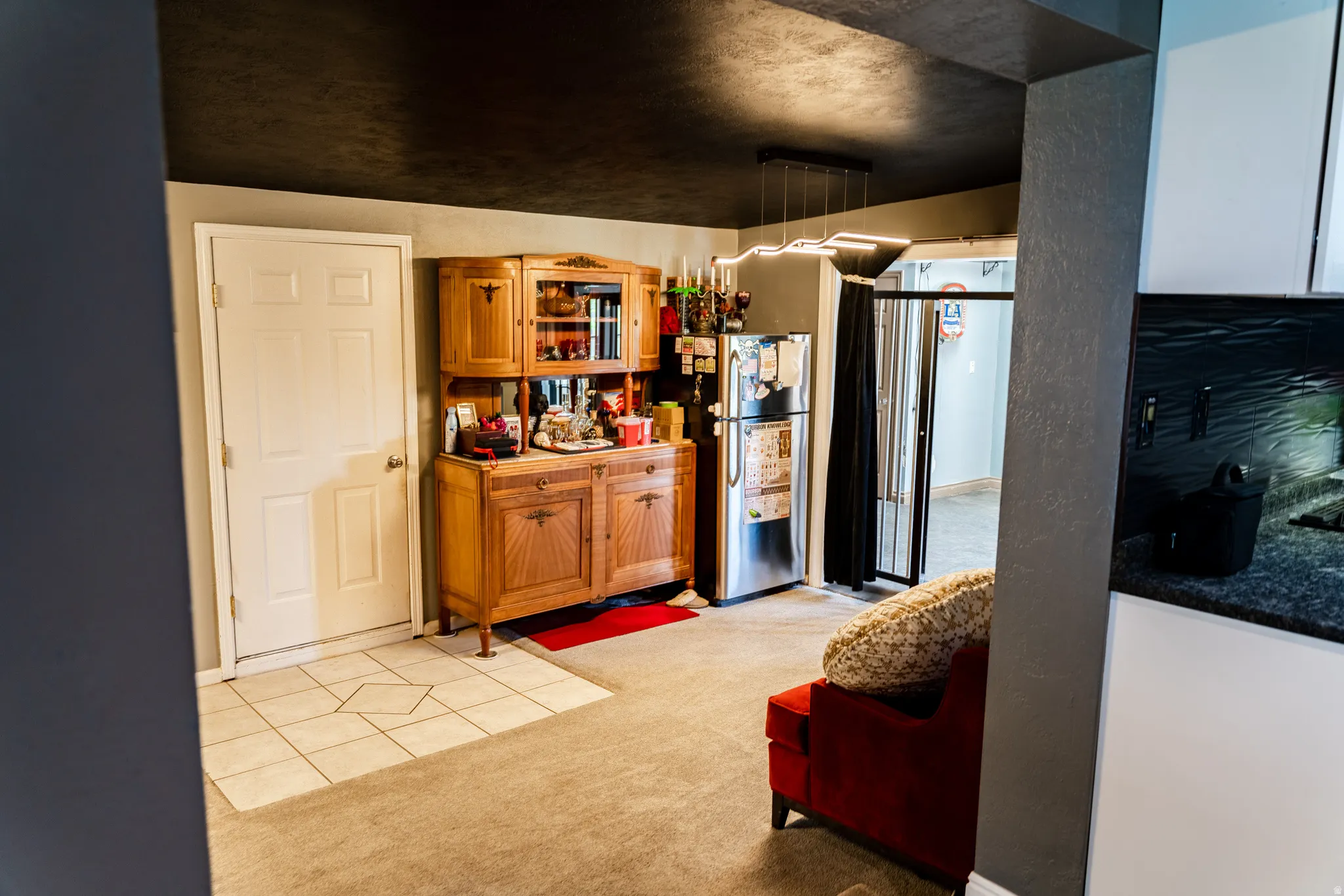 Recessed lighting, tiled flooring, built-in cabinetry, dark countertops, and white cabinetry