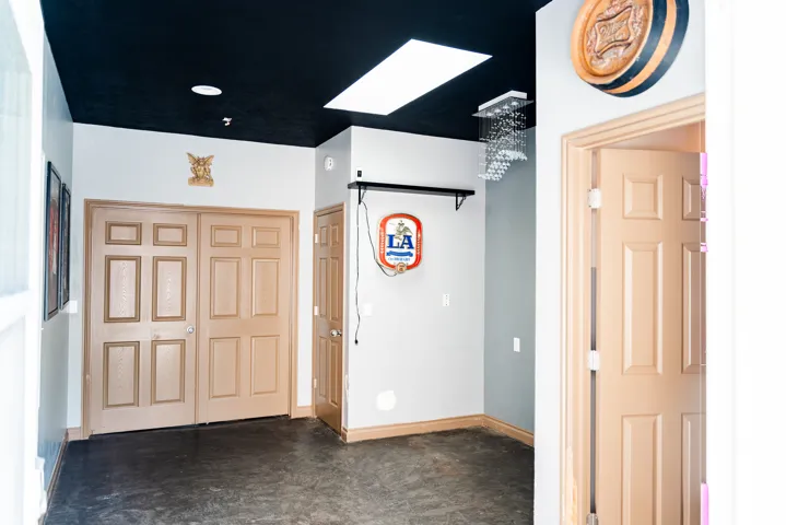 Recessed lighting, skylight, dark ceiling, gray wall accents, and panel doors