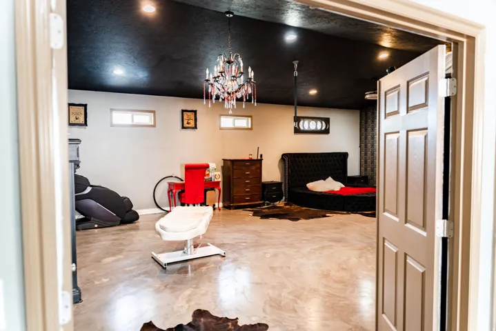 Recessed lighting, chandelier, and a dark-painted ceiling