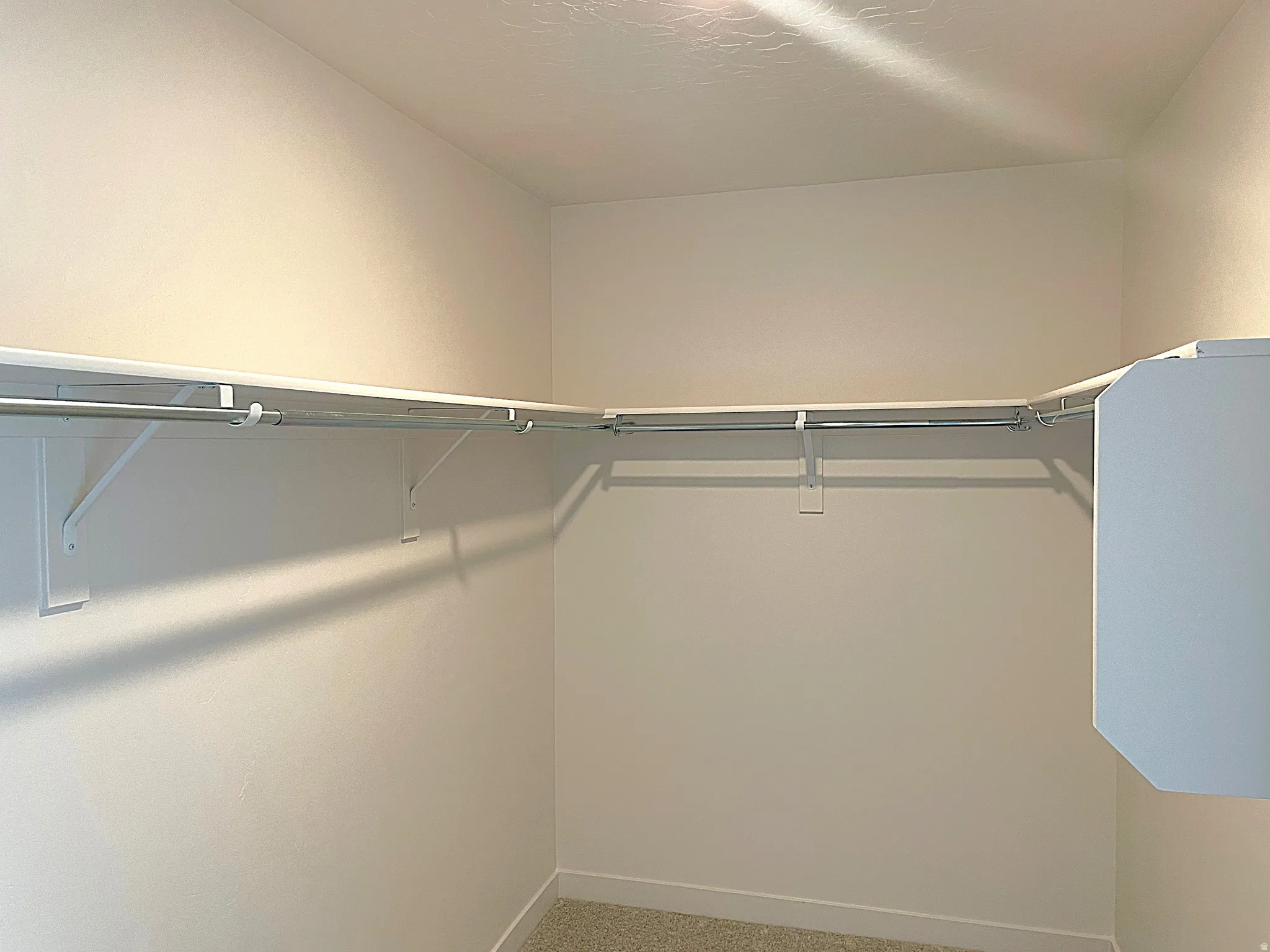 Walk-in closet with integrated shelving and hanging rods