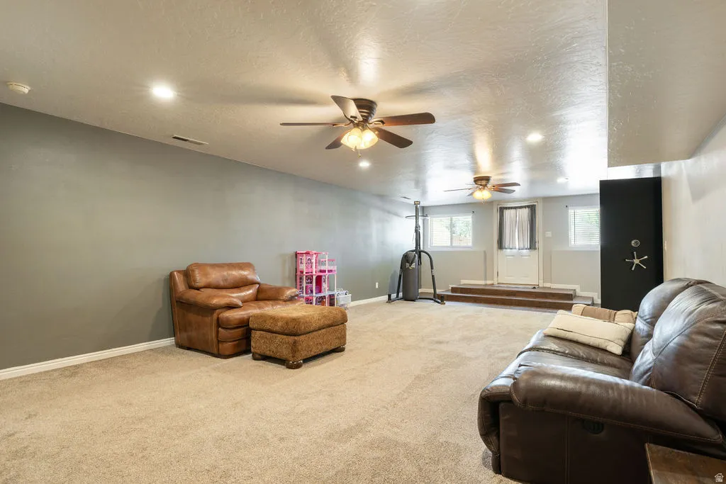 Recessed lighting, multiple ceiling fans, carpet flooring, a built-in safe, and a paneled white door