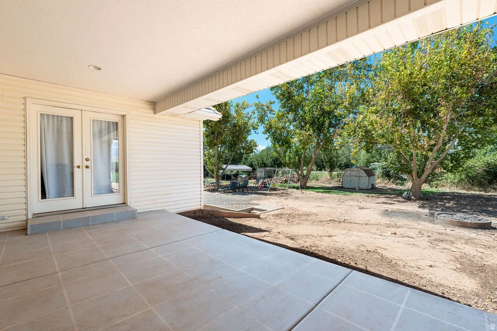Covered patio featuring concrete tile flooring and a recessed light