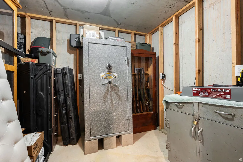 Unfinished concrete walls with exposed wood framing, concrete flooring, and exposed ceiling