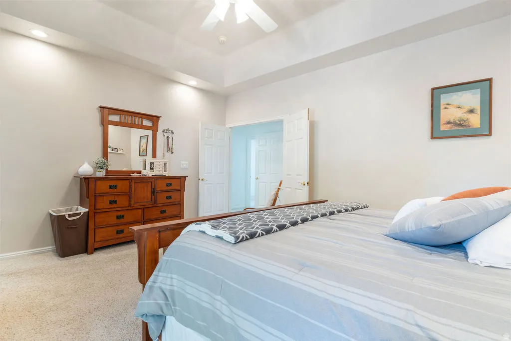 Tray ceiling featuring recessed lighting and a ceiling fan