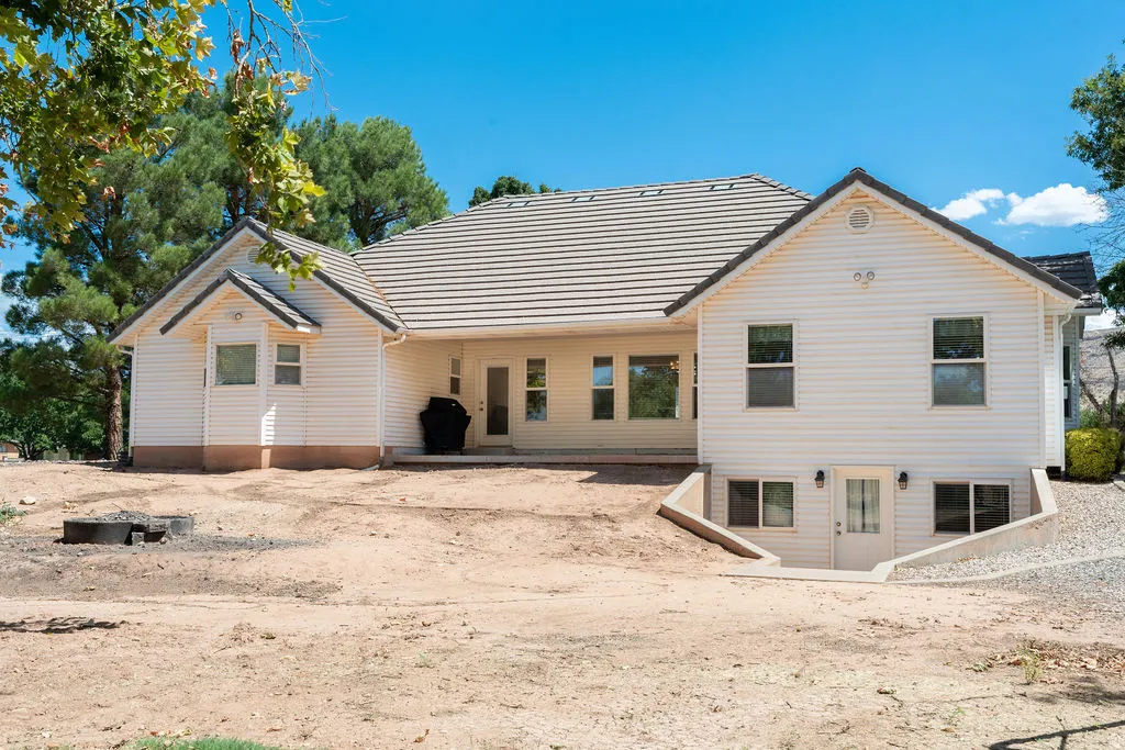 White siding exterior with a light-colored tile roof
