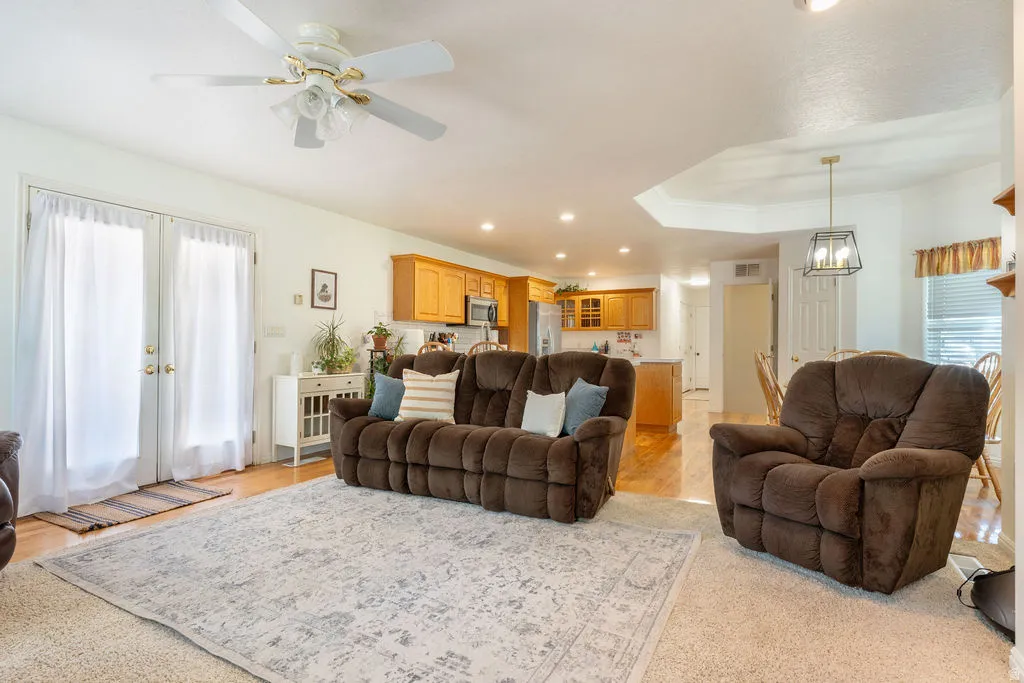 French doors, tray ceiling, recessed lighting, wood-finish flooring, ceiling fan with integrated lighting