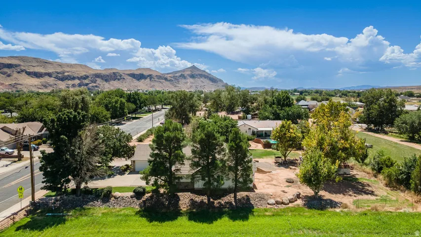 Expansive property featuring mature trees and a residential street