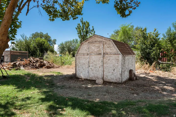 Gable-roof storage shed with shingled roof