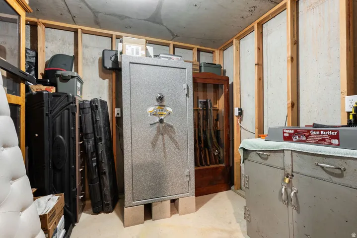Unfinished concrete walls with exposed wood framing, concrete flooring, and exposed ceiling