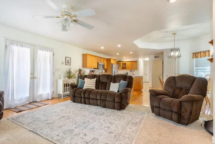 French doors, tray ceiling, recessed lighting, wood-finish flooring, ceiling fan with integrated lighting