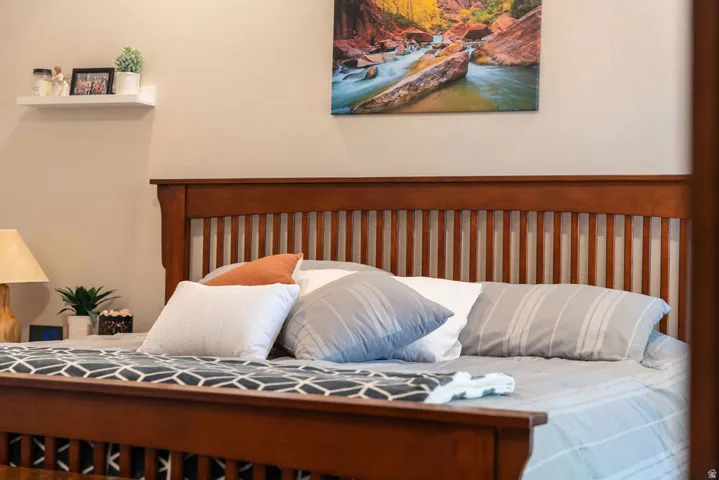 Wood-finish bed frame with a slatted headboard and footboard