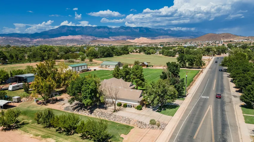 Expansive property with a large driveway and mature landscaping