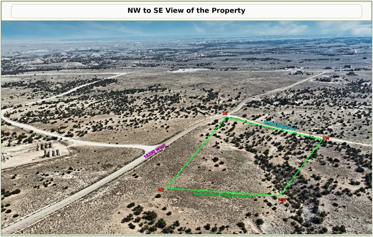 Aerial perspective of a land parcel featuring a visible road network and arid landscape