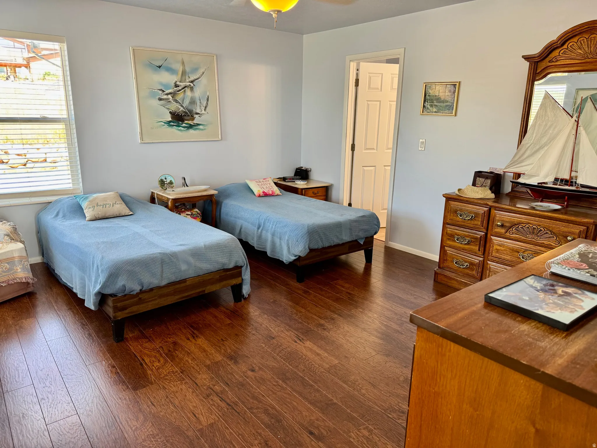 Wood-finish flooring throughout primary bedroom