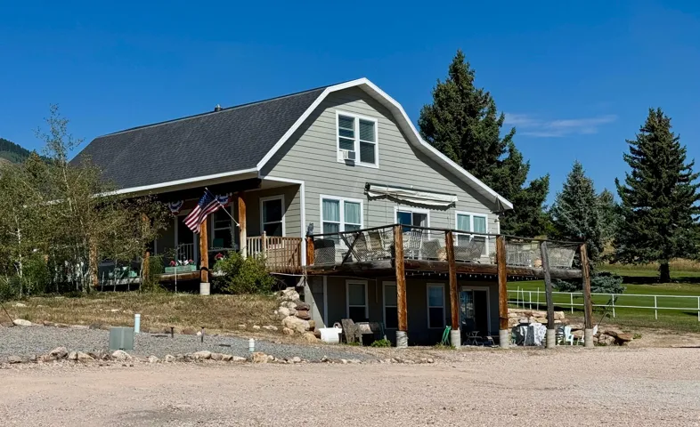 Two-story residence featuring a gambrel roof and Hardi-board siding