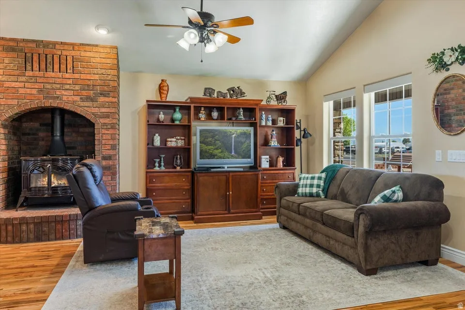 Vaulted ceilings, a brick-surround wood-burning stove, and wood-finish flooring