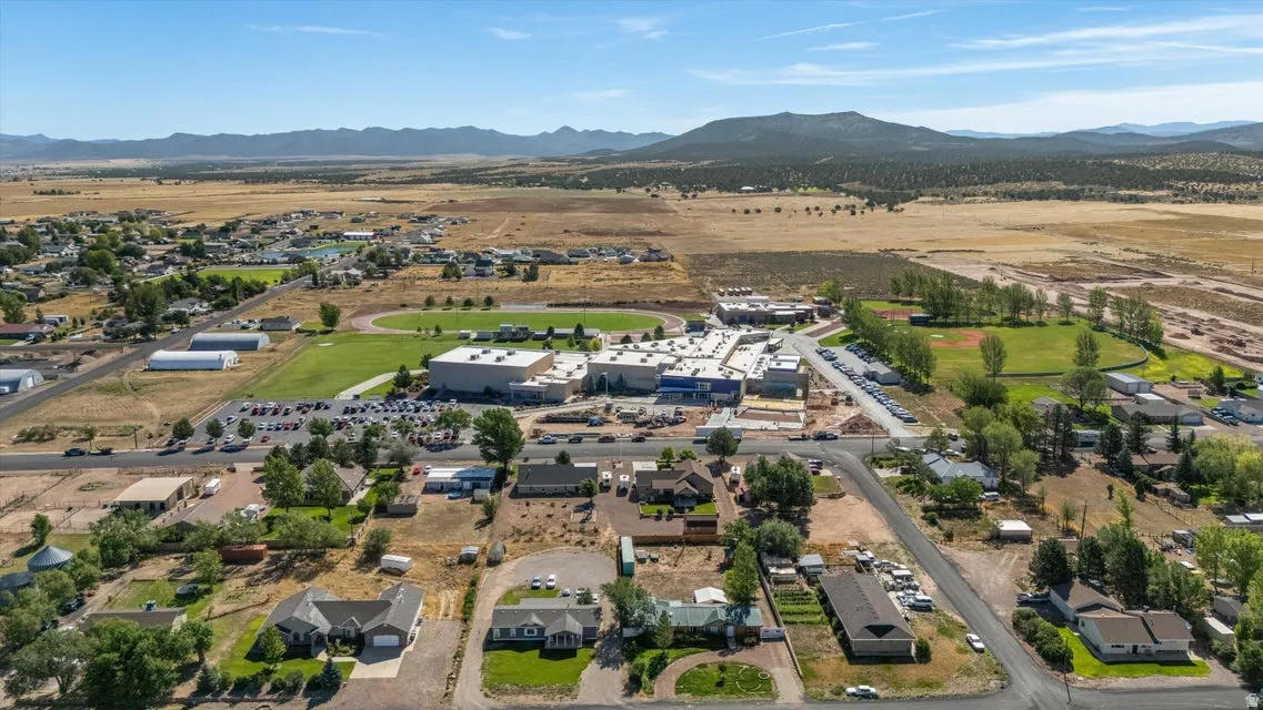 Expansive rural landscape featuring distant mountains and open fields