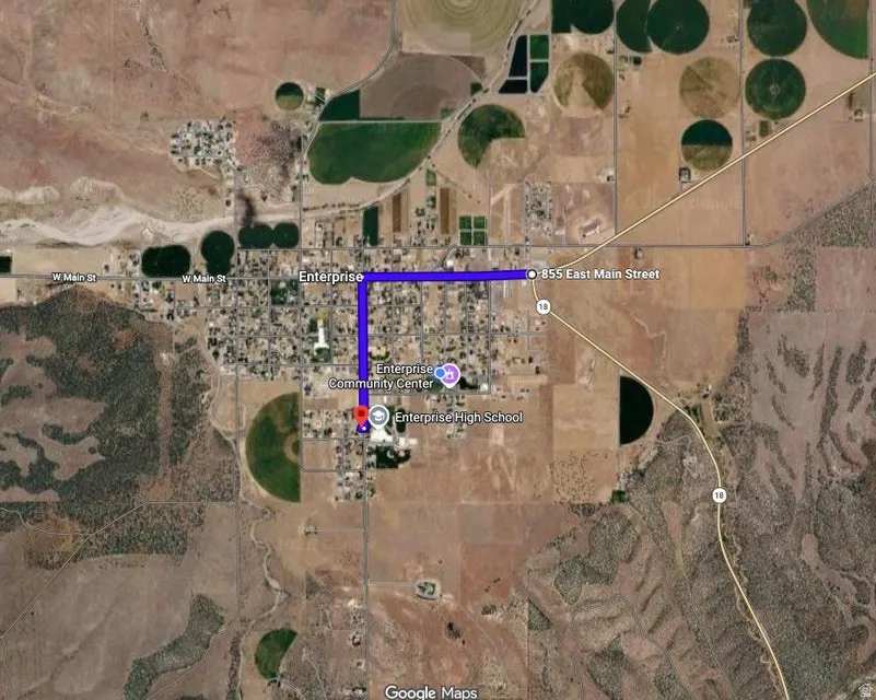 Satellite Map. Displaying a route from 855 East Main Street to Enterprise High School within Enterprise, with surrounding agricultural and undeveloped land visible