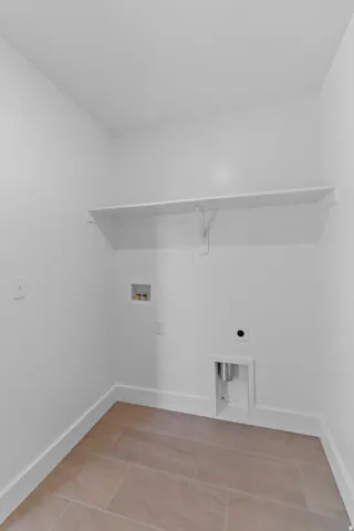White walls with a built-in shelf, and tile flooring