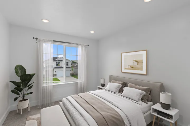 Recessed lighting, large window with sheer drapery, light gray walls, and carpet flooring