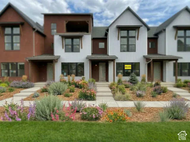 Contemporary architectural design featuring white vertical siding and dark trim