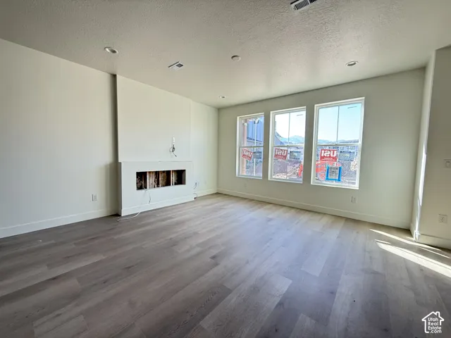 Wood-finish flooring, recessed lighting, and three panel windows