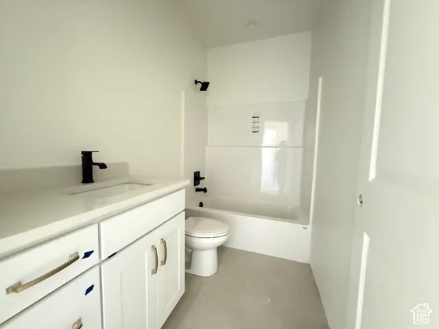 White flat-panel vanity with matte black faucet, integrated sink, and light countertop