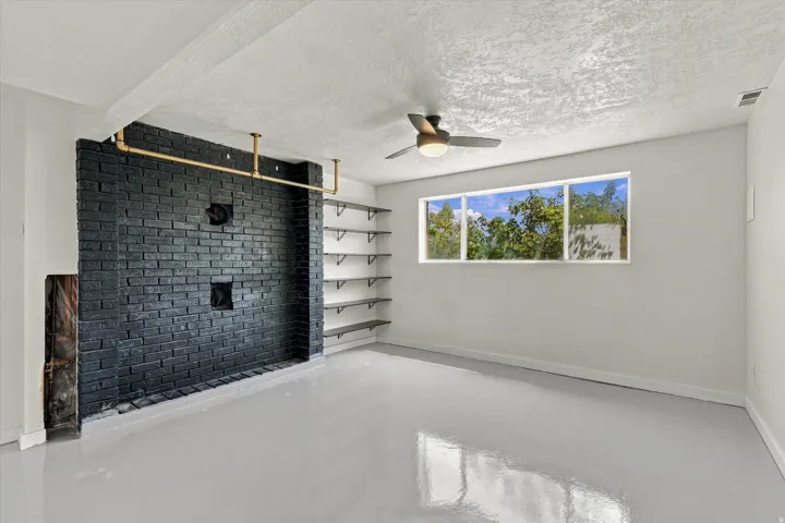 Black brick accent wall with gold-tone piping
