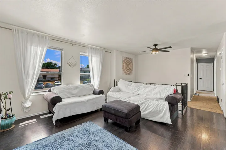 Dark wood-finish flooring, recessed lighting, and a ceiling fan