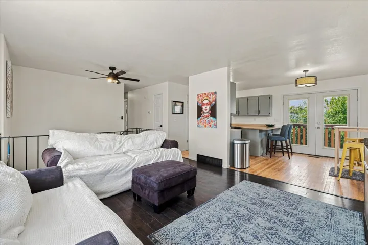 Dark wood-finish flooring, recessed lighting, and a ceiling fan