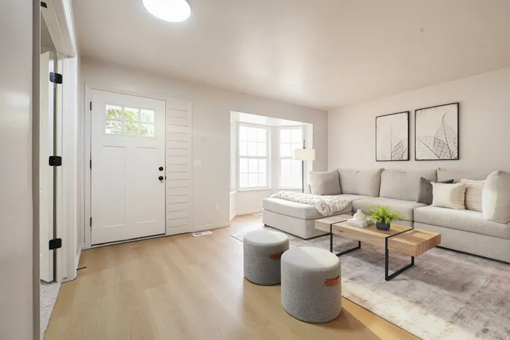 Entryway with wood-finish flooring, white paneled door with glass inserts, and shiplap accent wall