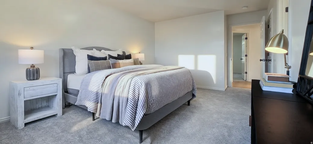 Plush carpeting, light-toned wall finishes, and a doorway with a panel door
