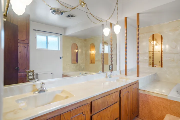 Double vanity with integrated sinks and chrome fixtures