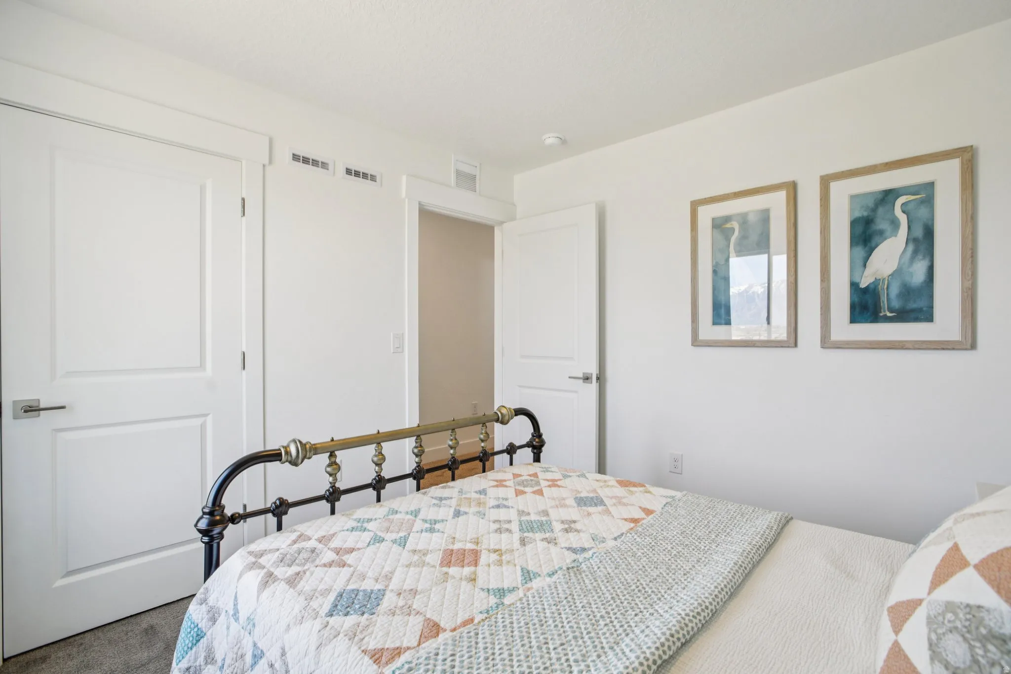White interior doors with brushed nickel hardware, recessed ceiling lighting, and light-colored wall paint