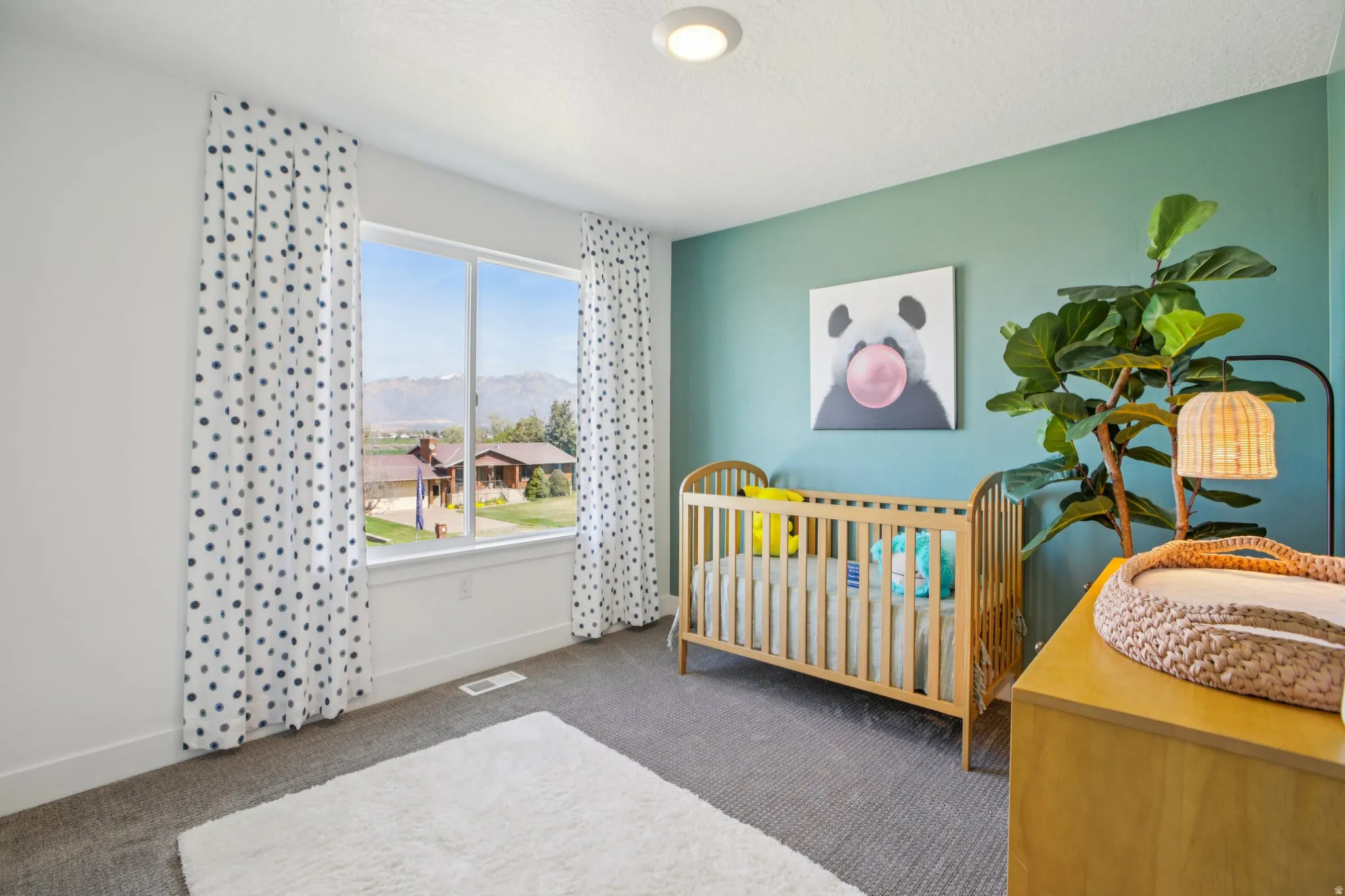 Recessed ceiling light, expansive window, carpeted flooring, and a painted accent wall