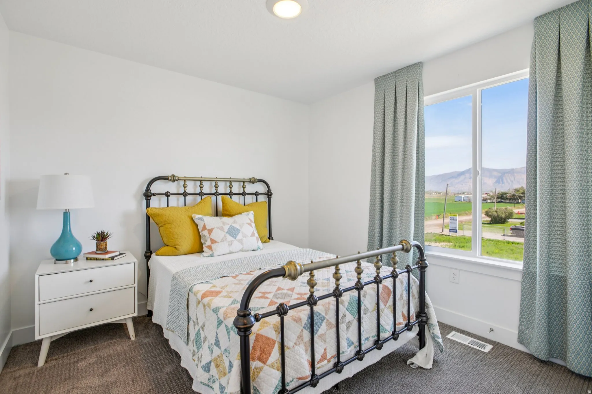 Bright bedroom featuring a large window, recessed lighting, and soft carpeting