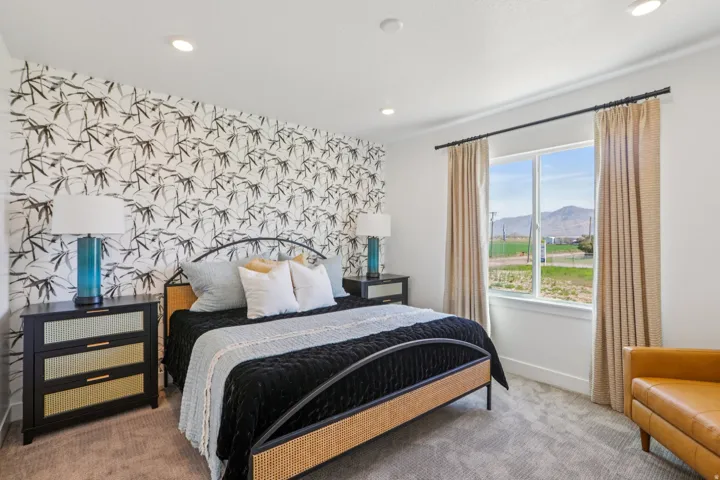 Accent wall with patterned wallpaper, window with white trim, recessed lighting, and carpeted flooring