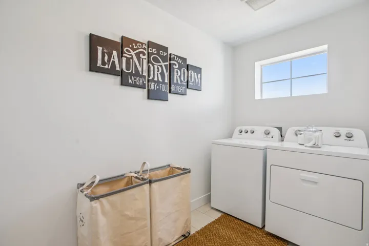 Laundry area with white walls and a window