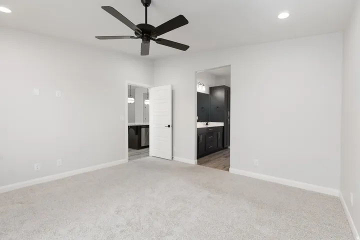Plush carpet, recessed lighting, and a modern ceiling fan with a matte black finish