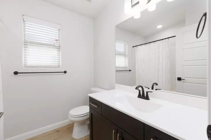 Sleek vanity with white countertop and integrated sink
