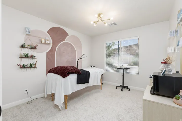 Recessed wall shelving, an overhead light fixture, and a window with horizontal blinds