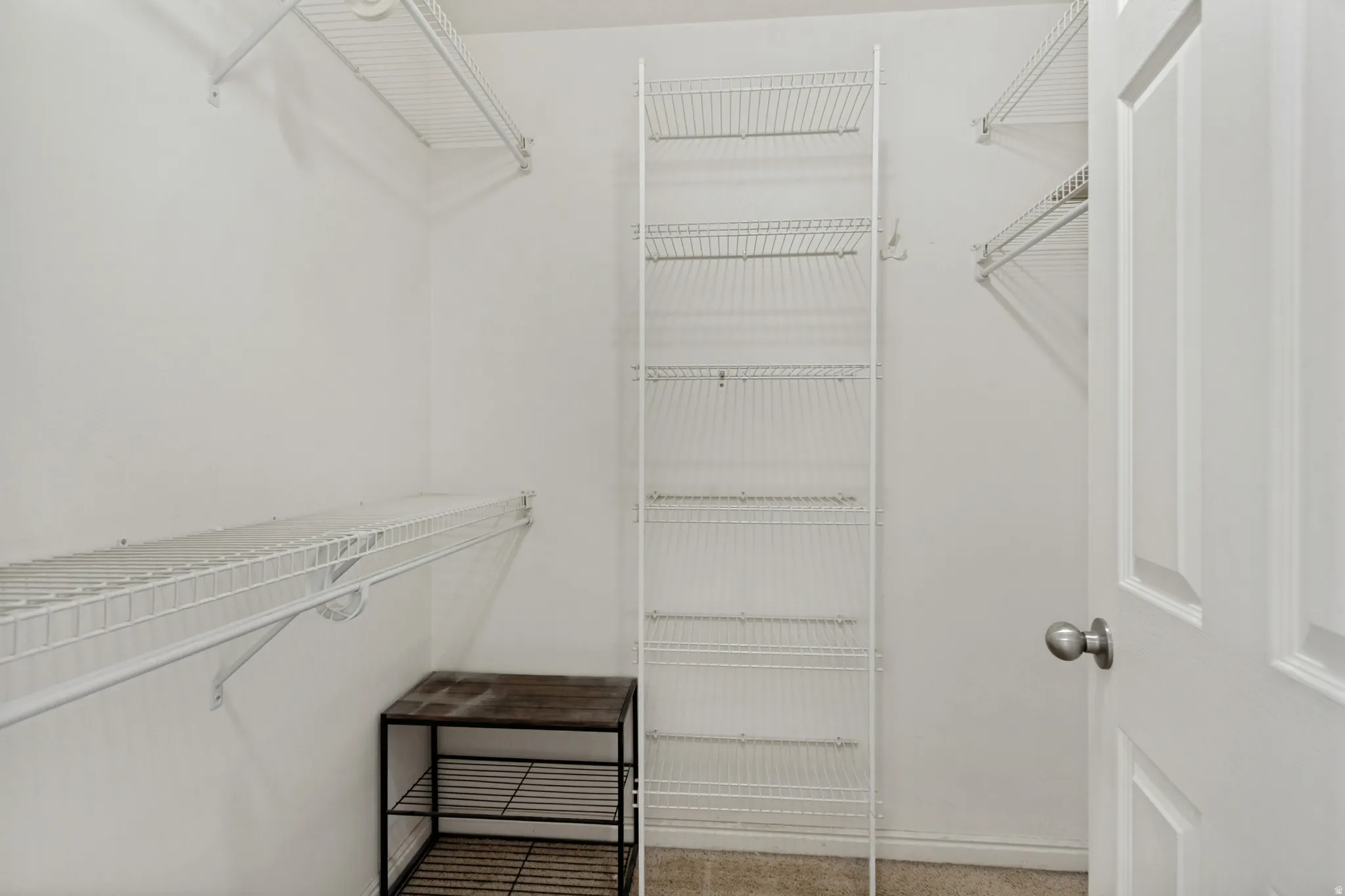 Closet featuring multiple wire shelving units