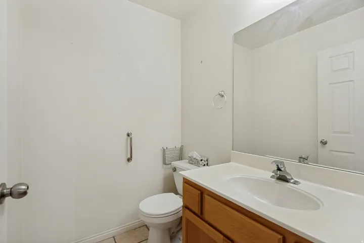 Vanity with wood-finish cabinetry and integrated sink