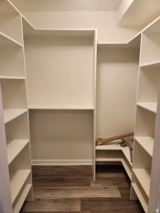 Built-in shelving with multiple storage levels and wood-finish flooring