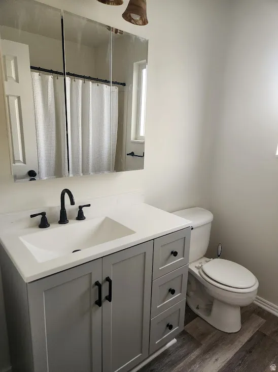Vanity with integrated sink, matte black faucet, gray cabinetry, and three storage drawers