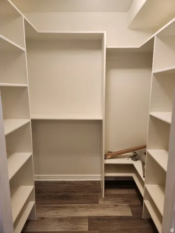 Built-in shelving with multiple storage levels and wood-finish flooring