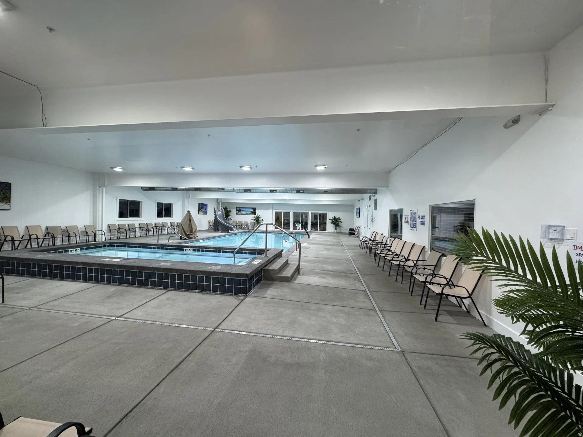 Indoor swimming pool with an integrated hot tub and pool slide