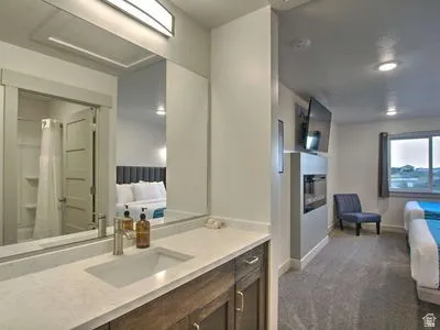Integrated vanity with a single basin sink and wood-finish cabinetry