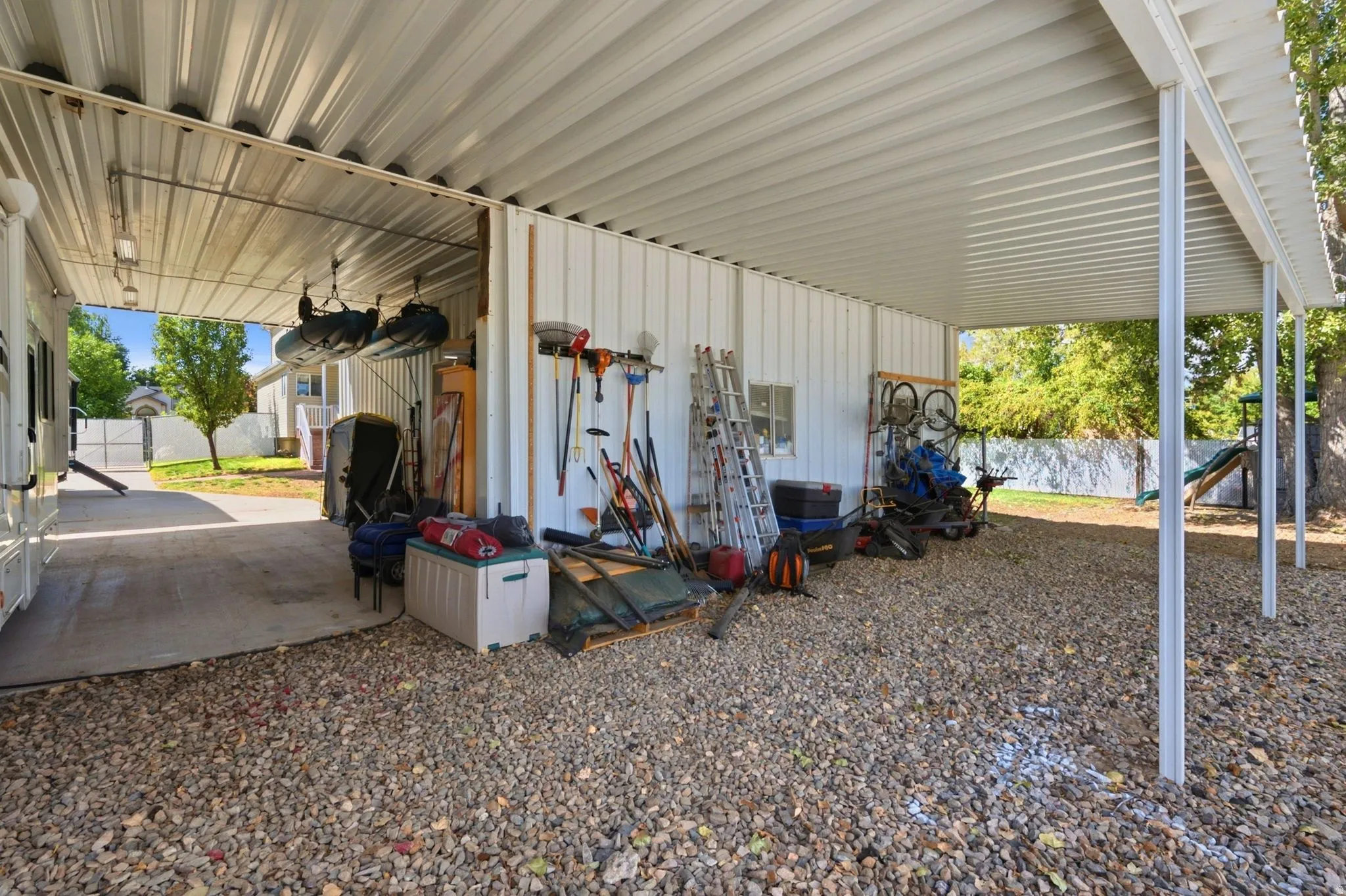 Expansive covered carport with durable metal roofing and structural support columns